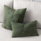Basketweave Fern square and lumbar pillows styled on a neutral indoor sofa