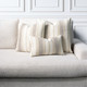 Axis Travertine square and lumbar pillows styled on a neutral indoor sofa
