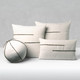 Micro Fringe Grigio square, orb and lumbar pillows styled on a neutral indoor sofa