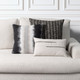 Micro Fringe Grigio lumbar pillow styled on a neutral indoor sofa