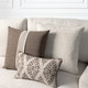 Forma Travertine lumbar pillow styled on a neutral indoor sofa