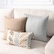 Revival Anew lumbar pillow styled on a neutral indoor sofa