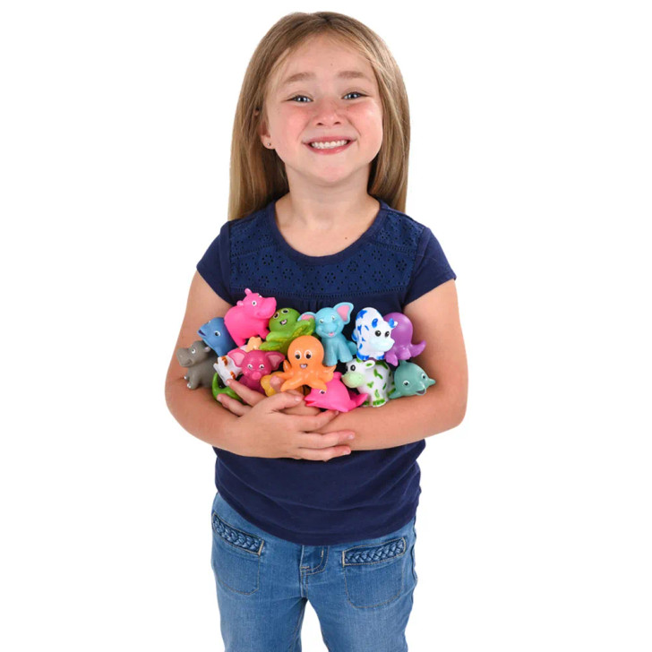 Rubber animal mix squirting 2" 432 pcs bulk toy gifts assortment held in girls arms.