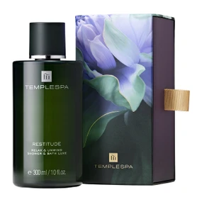 TEMPLESPA Restitude Relax and Unwind Shower and Bath Luxe 300ml bottle next to purple floral presentation box
