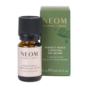 NEOM Wellbeing Perfect Peace Essential Oil Blend 10ml amber bottle standing next to its green packaging box on a plain white background.