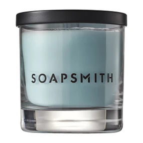 Soapsmith soft blue scented candle in a clear glass vessel with a black lid; a handmade London soy wax candle with patchouli, sandalwood and incense and around 40 hours’ burn time.