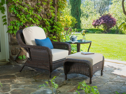 dark brown wicker club chair, ottoman, and table