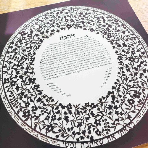Angled view of Flowery Flourish Ketubah cut from dark plum by Melanie Dankowicz