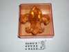 Molded Plastic Fleur-de-lis Neckerchief Slide, orange with plastic box by J-Mar
