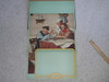 Norman Rockwell Poster Of An Old Sea Man Teaching a Boy Scout and Sea Scout With Room For Publicity, 28"x16", Folded Twice But In Excellent Condition, Partially Affixed to Scrapbook Paper