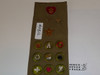 1940's Boy Scout Merit Badge Sash with 22 tan crimped merit badges, 2 early rank patches and some pins, #FB12