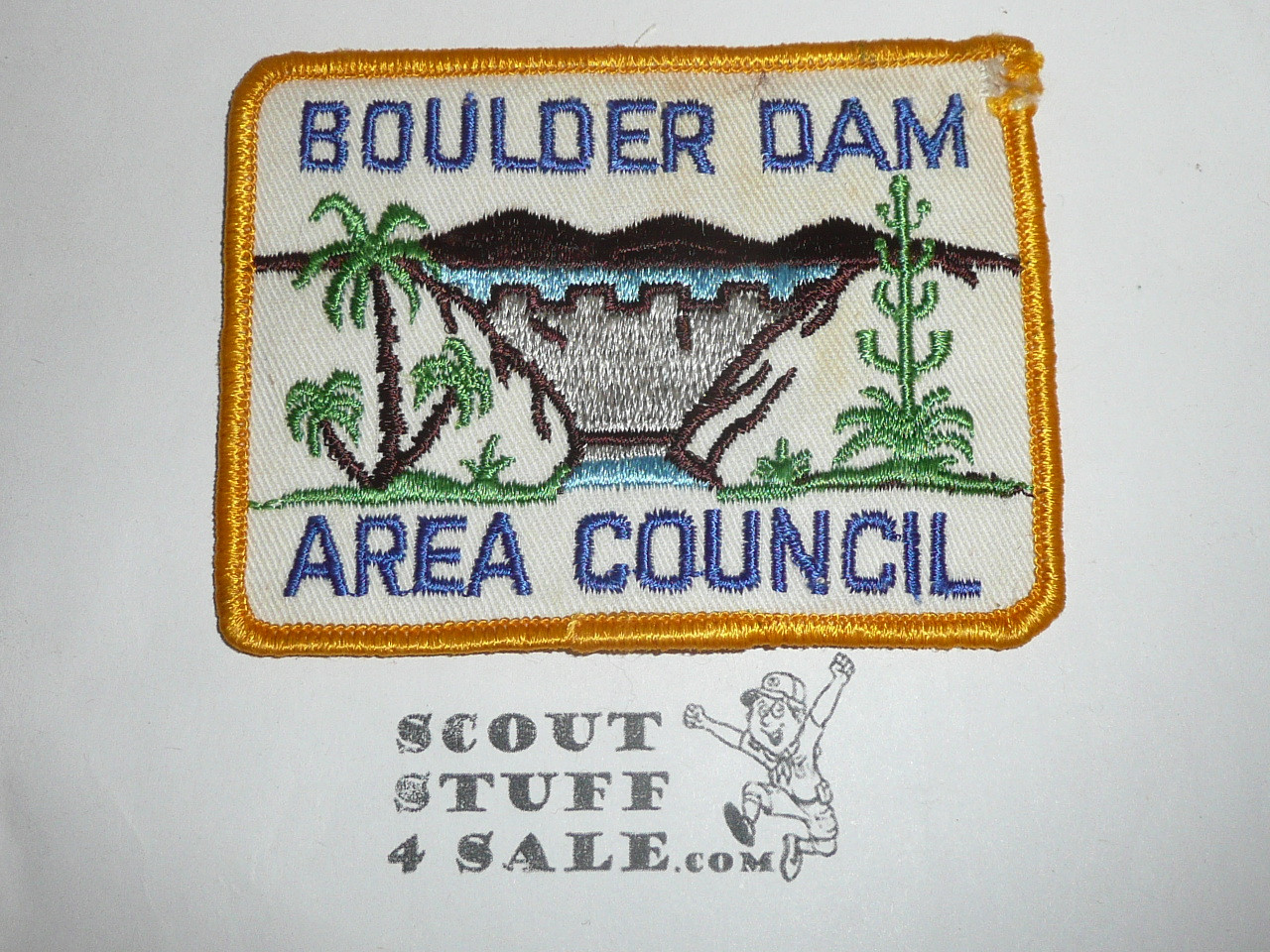 Boulder Dam Area Council Patch (CP), yellow r/e on white twill, bdr damage at upper right