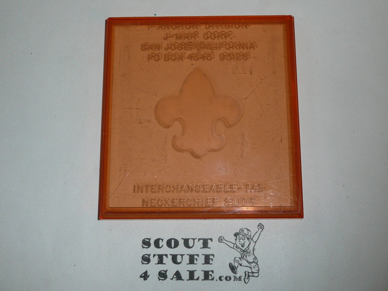 Molded Plastic Fleur-de-lis Neckerchief Slide, orange with plastic box by J-Mar
