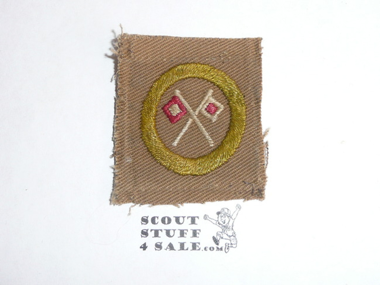 Signaling - Type A - Square Tan Merit Badge (1911-1933), reversed flags, black striped back, used