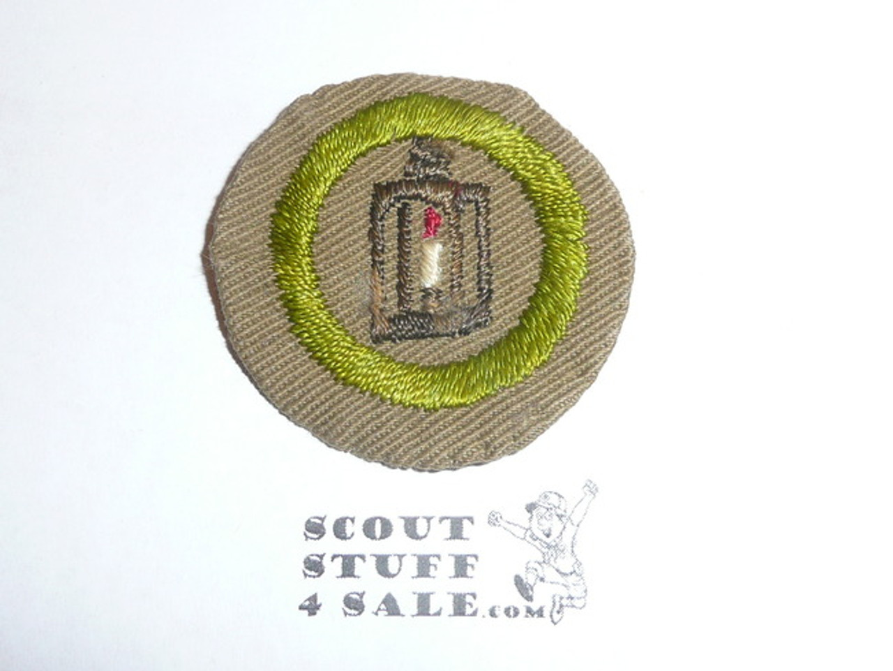 Metalwork - Type B - Wide Crimped Bdr Tan Merit Badge (1934-1935), was sewn but in very good condition