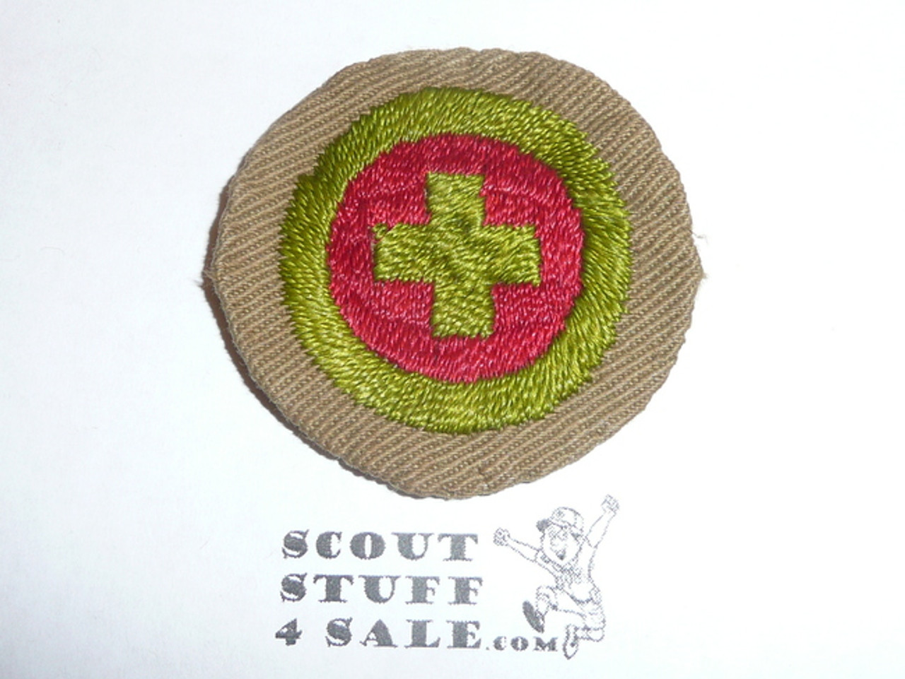 First Aid - Type B - Wide Crimped Bdr Tan Merit Badge (1934-1935), was sewn but in very good condition