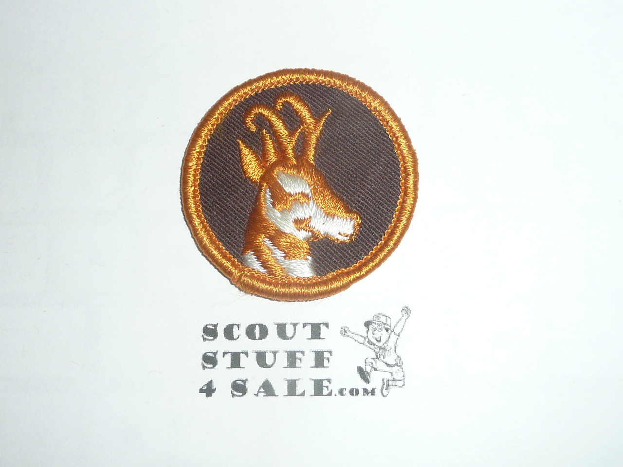Antelope Patrol Medallion, Rust color border and antelope, Brown Twill with plastic back, 1972-1989