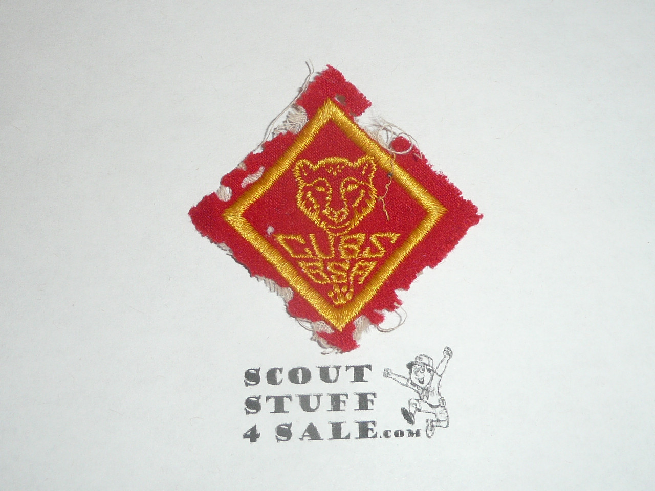 Bear Cub Scout Rank, felt with material extending over edge, moth eaten