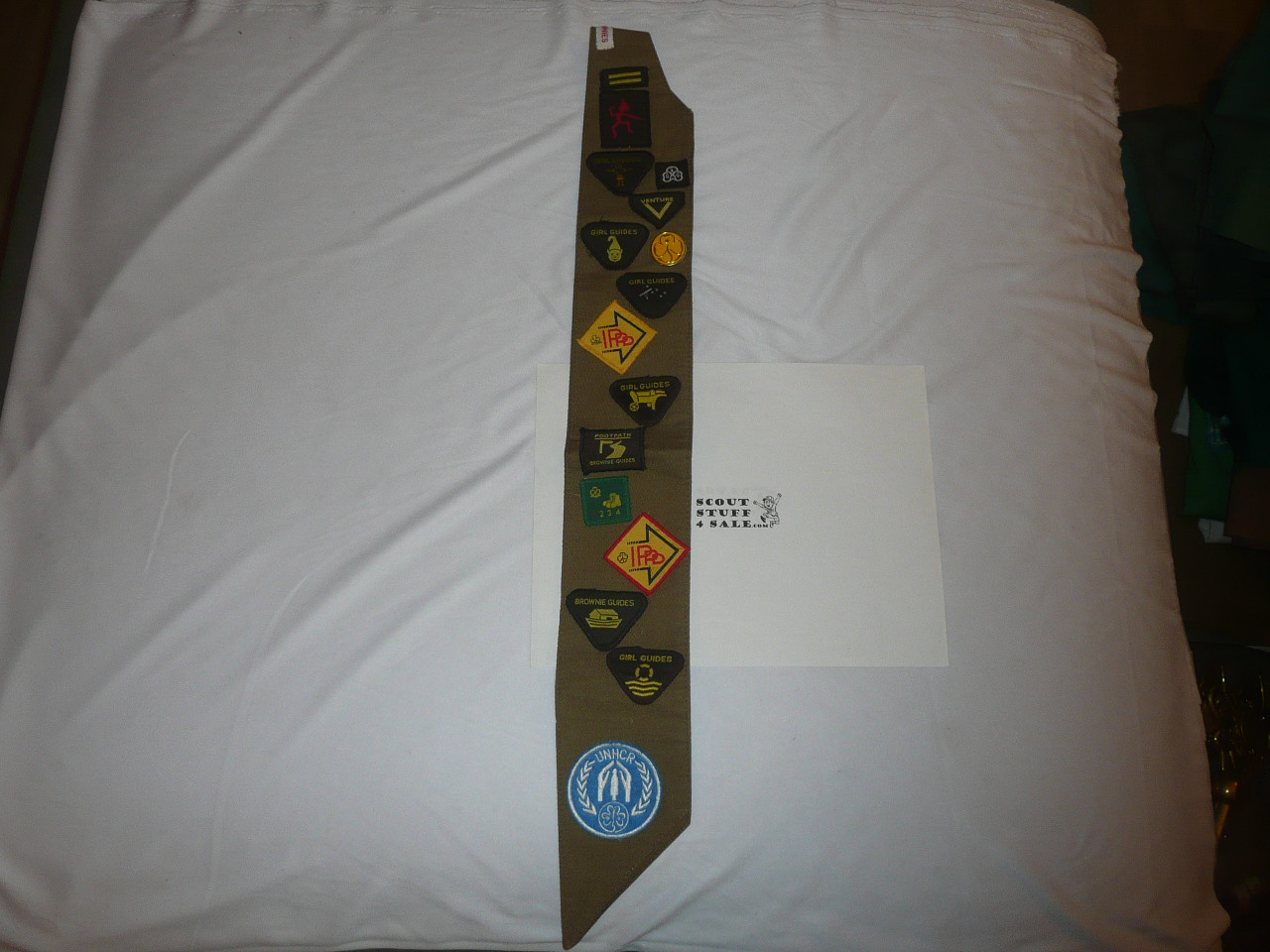 Girl Guides Badge sash with many badges and Unicef Patch