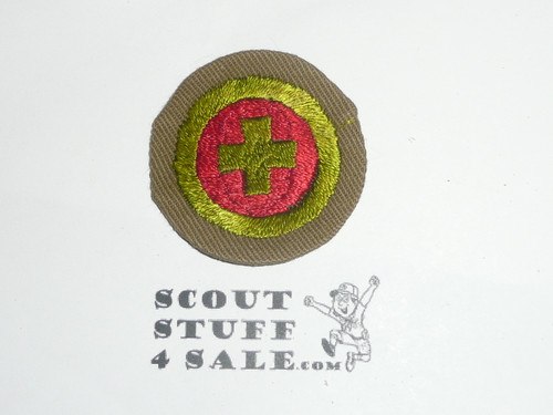 First Aid - Type B - Wide Crimped Bdr Tan Merit Badge (1934-1935)