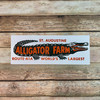 Retro-styled sticker with alligator and orange lettering against white background.