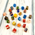 A diverse collection of colorful crafting beads and jewelry-making supplies spread out against a white background.