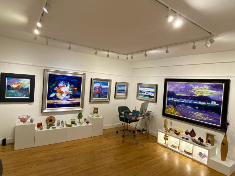 inside Glasgow Gallery showing art on the wall, ceramics on top of units.