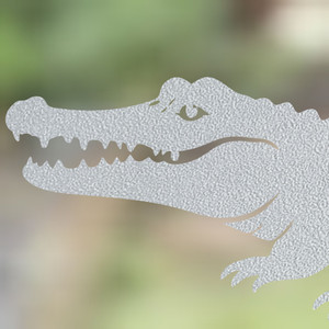 Close-up of a left-facing frosted Crocodile window cling clinging to glass, showing etched-glass texture and soft matte finish.
