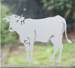 Close-up of a left-facing frosted Cow window cling clinging to glass, showing etched-glass texture and soft matte finish.