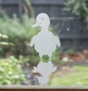 Close-up of a left-facing frosted Duck with Shadow window cling clinging to glass, showing etched-glass texture and soft matte finish.