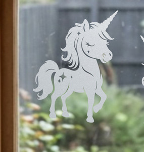 Close-up of a right-facing frosted  Sprinklesong - Unicorn window cling clinging to glass, showing etched-glass texture and soft matte finish.