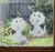 Two frosted Triceratops window clings displayed on a window, showing left and right-facing designs with etched-glass texture and soft matte finish.