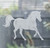 Close-up of a right-facing frosted  Galloping Horse window cling clinging to glass, showing etched-glass texture and soft matte finish.