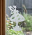 Close-up of a right-facing frosted   Tilly Tuffet - Fairy window cling clinging to glass, showing etched-glass texture and soft matte finish.