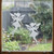 Two frosted  Liora - fairy window clings displayed on a window, showing left and right-facing designs with etched-glass texture and soft matte finish.