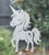 Close-up of a left-facing frosted Sprinklesong - Unicorn window cling clinging to glass, showing etched-glass texture and soft matte finish.