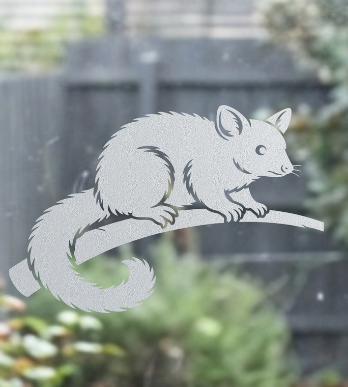 Close-up of a right-facing frosted  Brushtail Possum window cling clinging to glass, showing etched-glass texture and soft matte finish.
