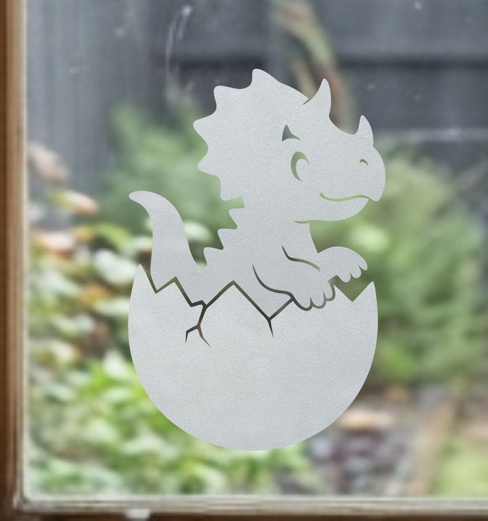 Close-up of a right-facing frosted  Baby Dinosaur window cling clinging to glass, showing etched-glass texture and soft matte finish.