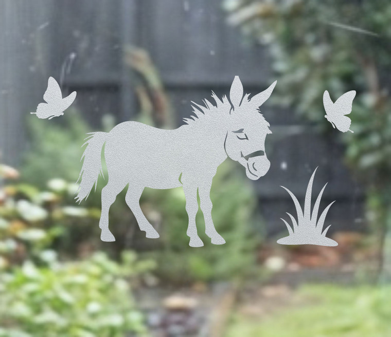 Close-up of a right-facing frosted  Donkey window cling clinging to glass, showing etched-glass texture and soft matte finish.