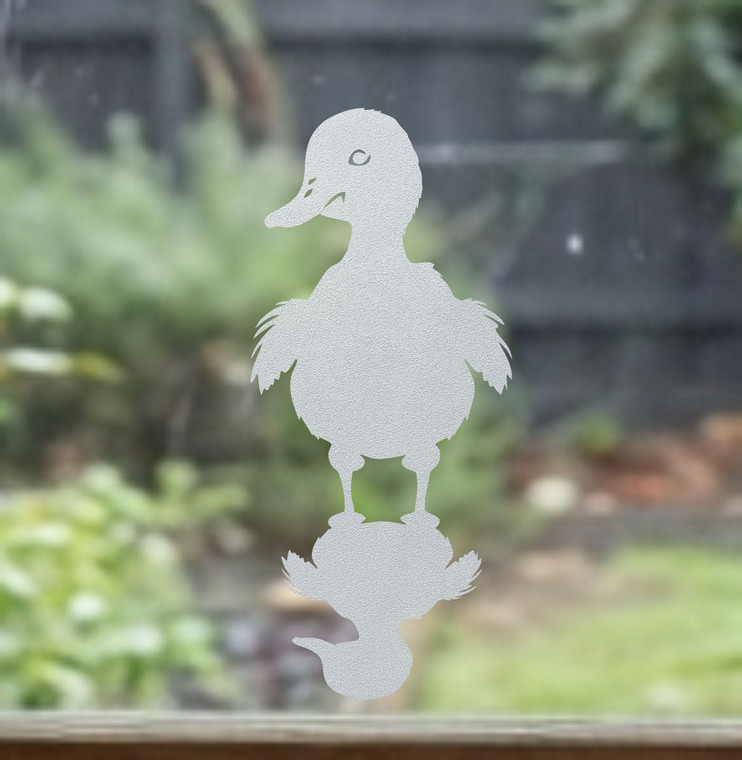 Close-up of a left-facing frosted Duck with Shadow window cling clinging to glass, showing etched-glass texture and soft matte finish.