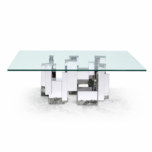 futuristic coffee table with geometric silver toned metal base and sleek glass top. futuristic coffee table with geometric silver toned metal base and sleek glass top.