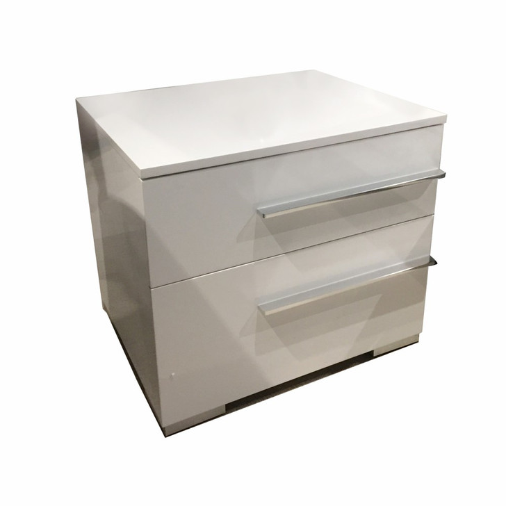 glossy white nightstand with off-center silver-toned handles
