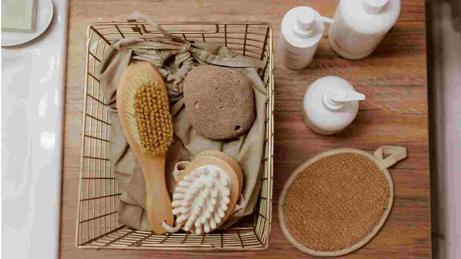 A basket containing skincare brushes and soap placed neatly on a countertop, showcasing essential skincare accessories.  