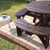 Circular picnic table painted dark brown using Royal Exterior Wood Finish - Warm Oak