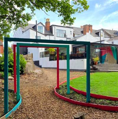 Pretty pergolas covered in vines and surrounded by elegant potted plants and flowers