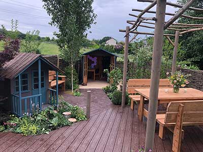 The Love Your Garden team created a terrace with a BBQ area outside the backdoor 