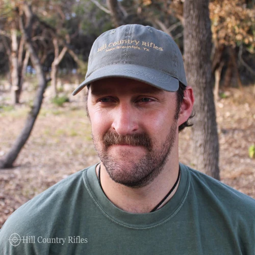 HCR Classic Dad Hat, gray cap with embroidered text and curved brim worn by a man outdoors.