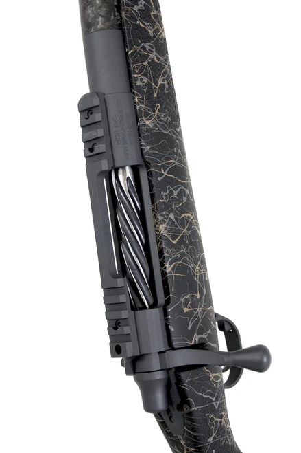 SOLD! Carbon Rifleman in 7 PRC, close-up image of the rifle showcasing its black and gold marbled design, bolt action, and tactical scope mount.