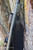 HCR Vero Vellini Rifle Sling in Black, attached to a rifle with a tree in the background.