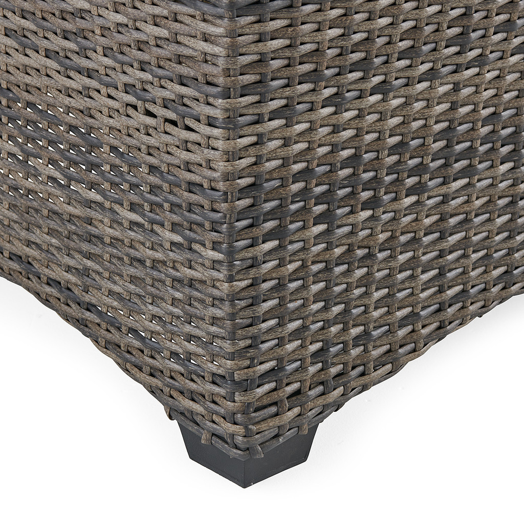 Bottom corner foot of wicker loveseat close-up